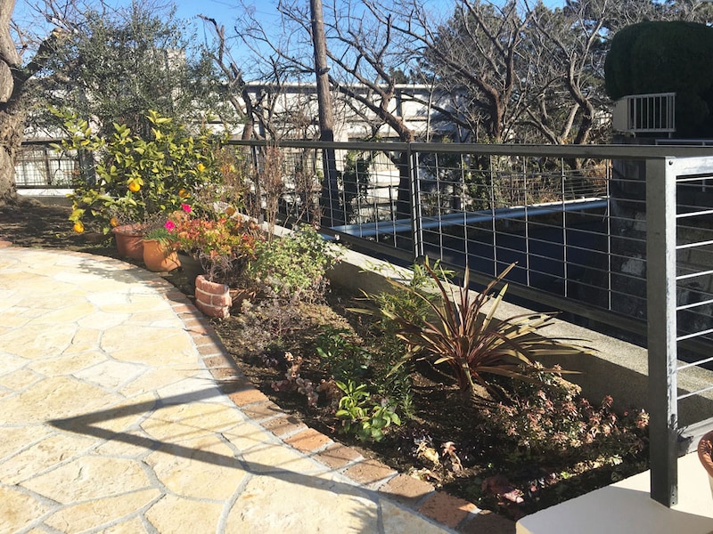 エントランスまでの道行きを彩るアプローチ脇の花壇。