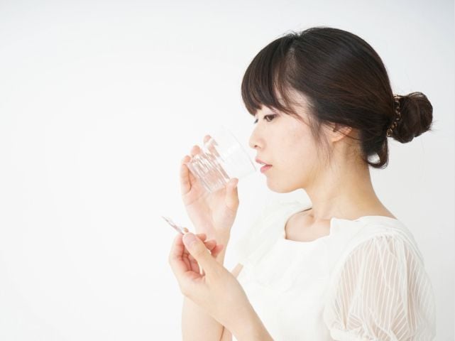 服薬する女性