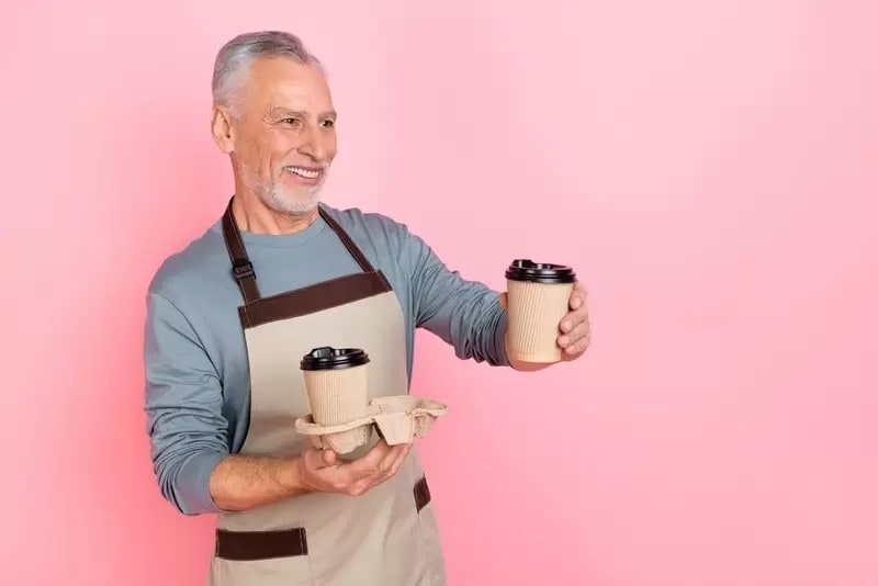 カフェで働くシニア男性