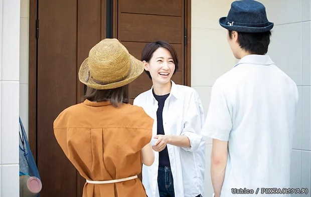 玄関前で話す人の写真