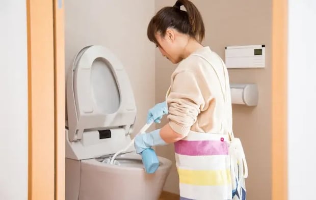 トイレ掃除をしている女性