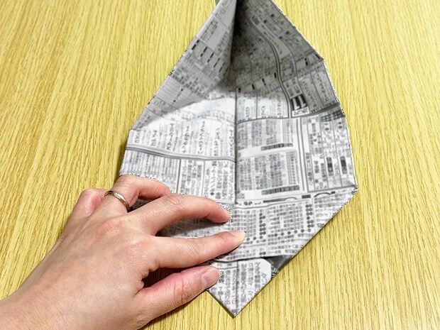 新聞紙の両端を内側に折っている画像（撮影：grapeライフハック編集部）