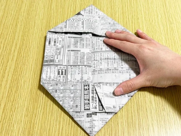 新聞紙の両端を内側に折っている画像（撮影：grapeライフハック編集部）