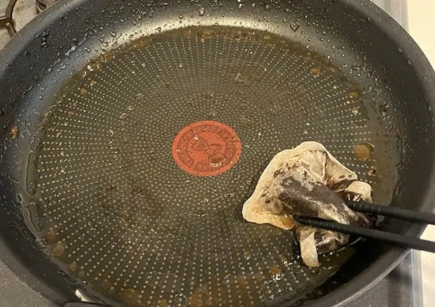 麦茶パックでフライパンをこすっている写真（撮影：grapeライフハック編集部）