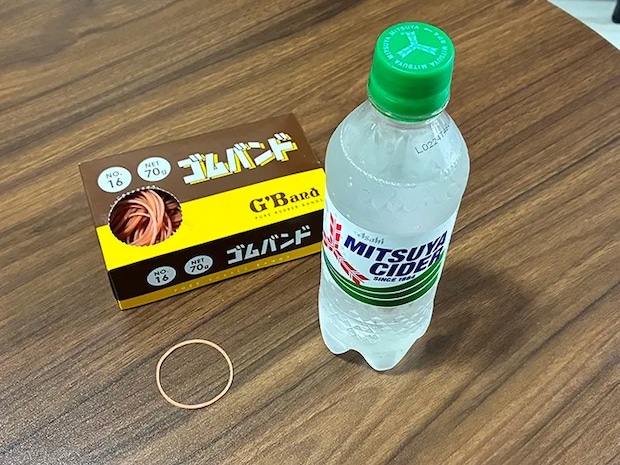 机に置かれた炭酸飲料と輪ゴムの写真（撮影：grapeライフハック編集部）