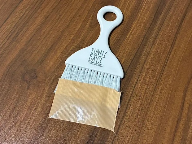 毛先にガムテープをつけたミニほうきの写真（撮影：grapeライフハック編集部）