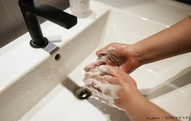 指先まで手を洗う人の写真