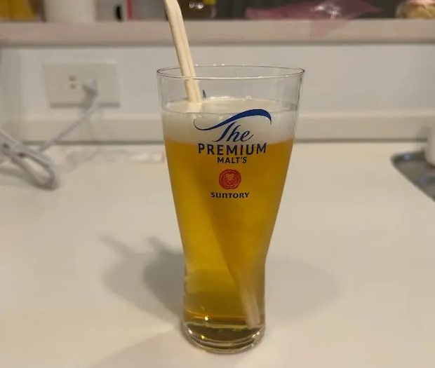 勢いよくビールに割り箸を入れる様子（撮影：grapeフード編集部）