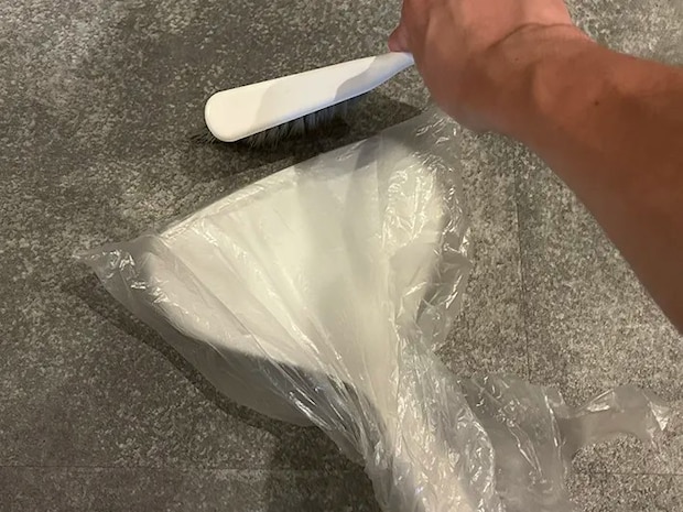 ビニール袋をかぶせたちりとりにゴミを集める場面（撮影：grapeライフハック編集部）