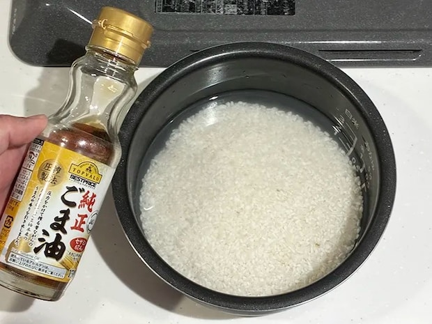研いだお米と、手に持ったごま油（撮影：grapeフード編集部）