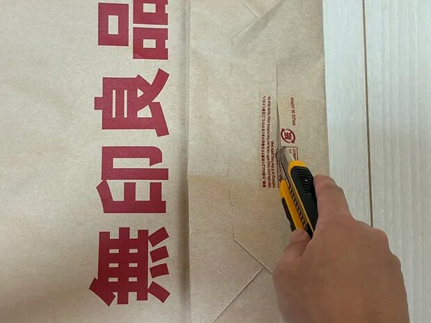 カッターで紙袋の底を切り取る場面（撮影：grapeライフハック編集部）