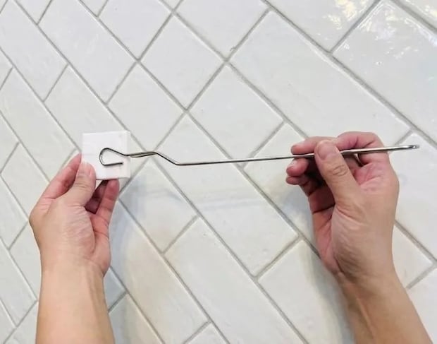ブラシをセットしたハンドルで便器を掃除している手元（撮影：grapeライフハック編集部）