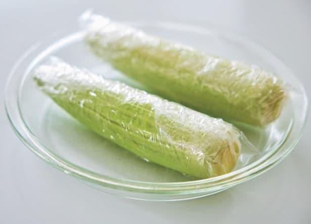 とうもろこしは内側の薄い皮を数枚残して、水けをつけたまま1本ずつラップで包む