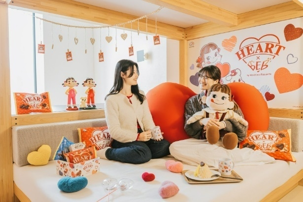【写真】ハートチョコレートの世界観に包まれたコラボルームで、ペコちゃんと一緒に過ごす特別なひととき