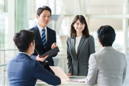 社内で話す会社員たち