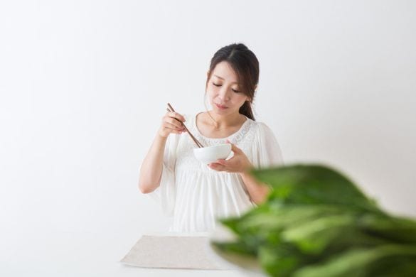 ほうれん草を食べる女性