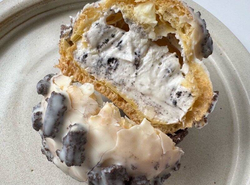 ホワイトチョコでコーティングされたザクザクとハードな食感のシューの中には、ミルクの優しい甘みを感じるクリームとココアクランチがイン