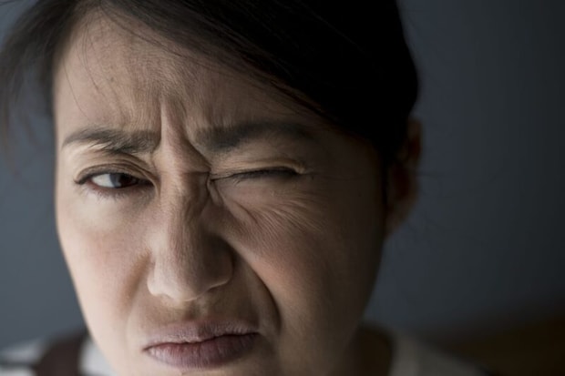 目をしかめる人