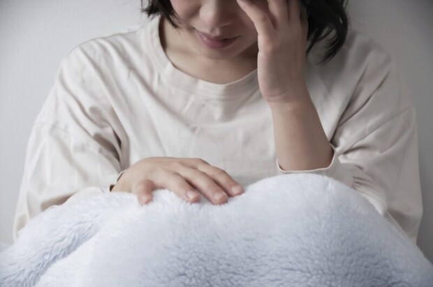 体調不良の女性