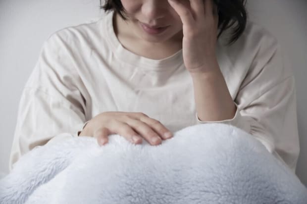 体調不良の女性