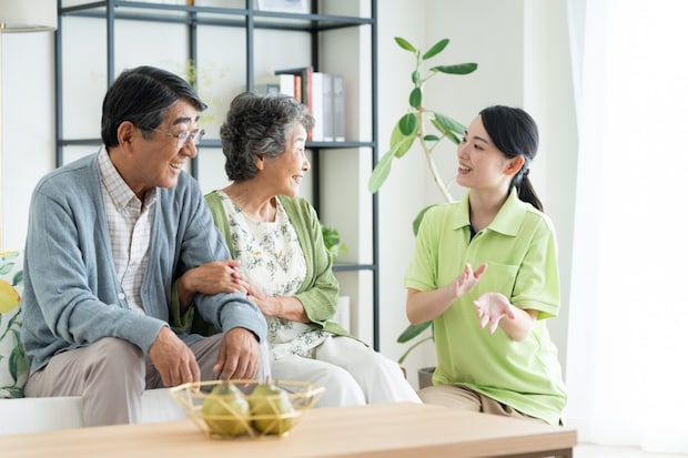 シニアの夫婦と介護福祉士
