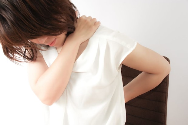 肩と腰に手を当てる女性