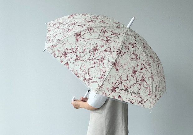 リリーの花柄の傘を差して立っている人物の後ろ姿