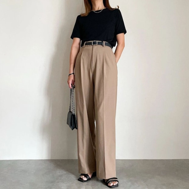 黒シアーTとベージュワイドパンツを着用した女性 黒シアーTとベージュワイドパンツを着用した女性