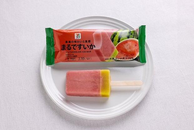 セブンプレミアム まるですいかのアイスバーとパッケージ。白い布地の上に置かれている。