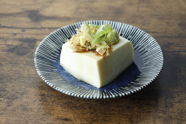 青釉たれ皿に薬味を乗せた冷奴が盛り付けられている