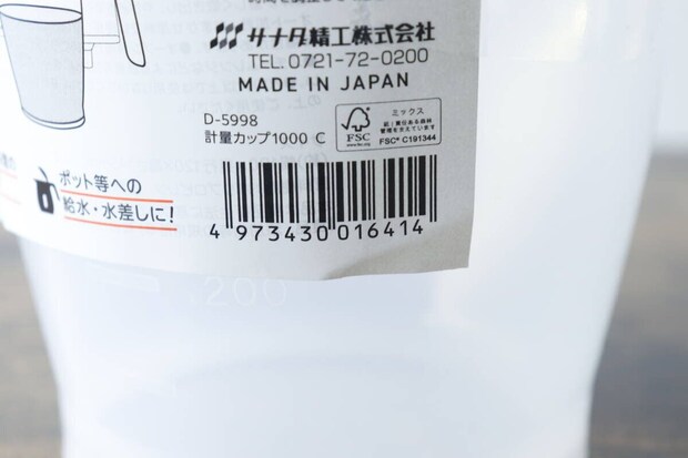 計量カップに貼られた商品パッケージのバーコード部分のアップ
