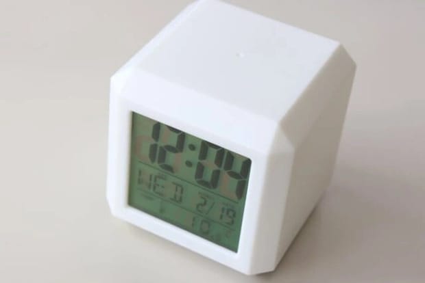 白いデジタル時計が時刻、日付、曜日、温度を表示