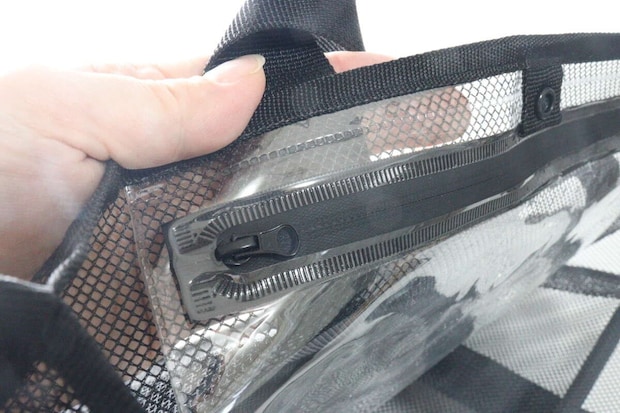 メッシュバッグの内側にある防滴袋の止水ファスナー部分を指でつまんでいる。 メッシュバッグの内側にある防滴袋の止水ファスナー部分を指でつまんでいる。